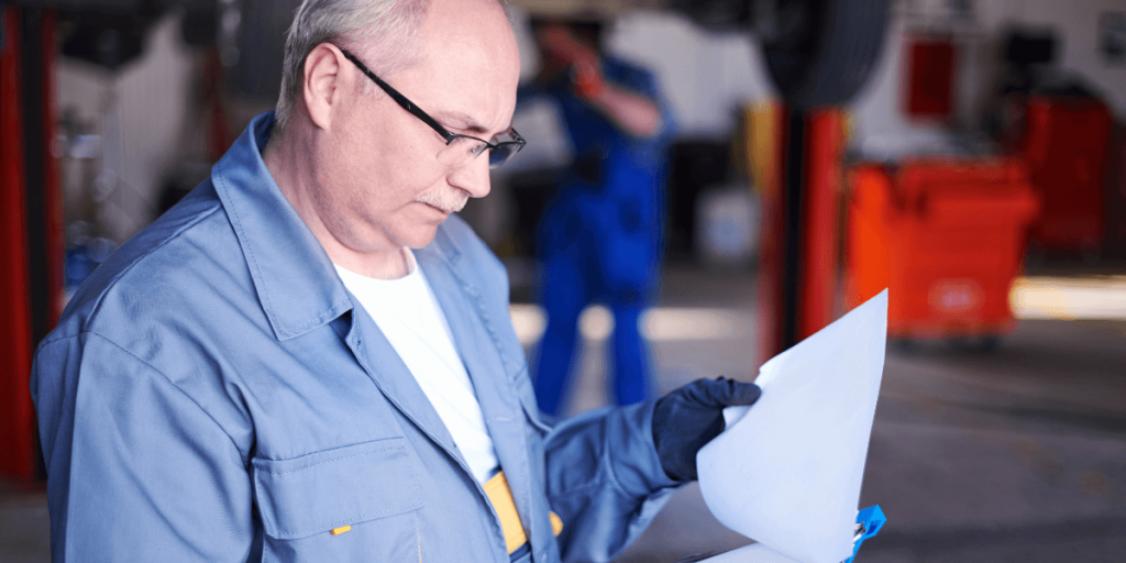 mechanic-checking-car-report